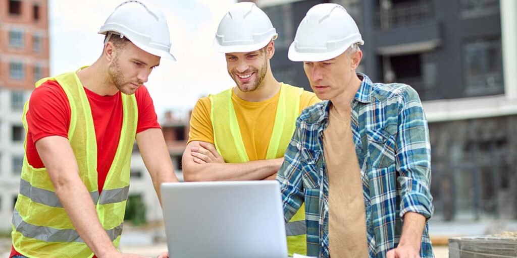laptop with construction workers